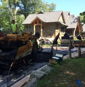 Paving a driveway by G and H Asphalt in Des Moines, Iowa